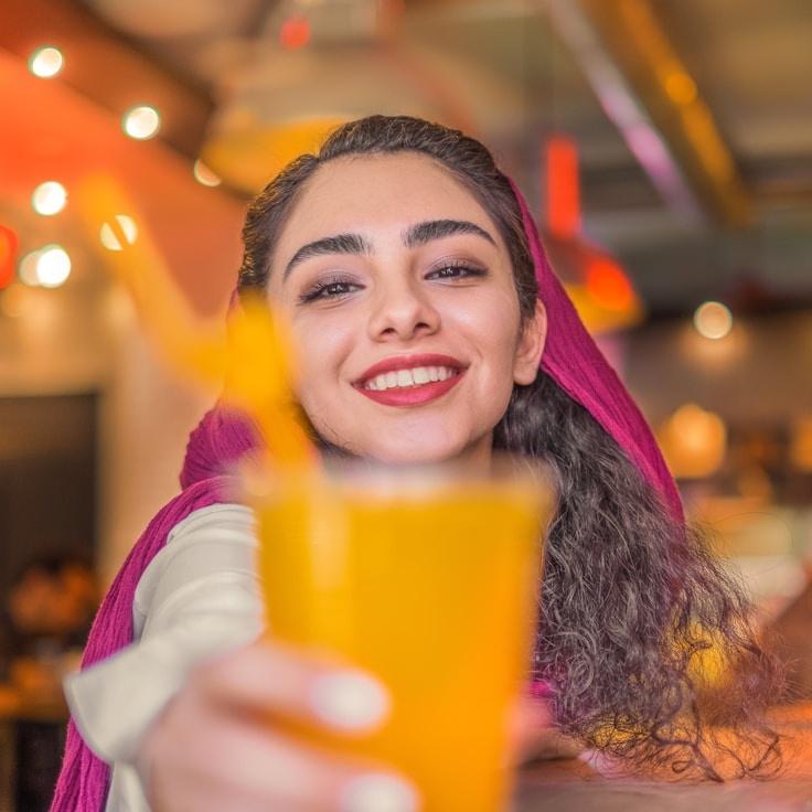 Aisha Kapoor, Lead Design Curator at HarborPaperView, reviewing corporate floral arrangements